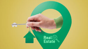 Hand holding house keys and location pin, real estate concept